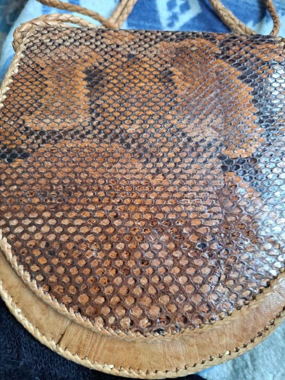 vintage snakeskin bag is likely a 1970s saddle or envelope-style crossbody purse